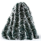 Decorative tinsel tree with a hand holding it on a white background